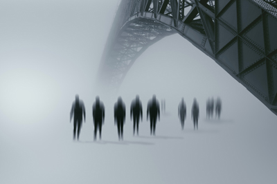 A picture of zombies walking under a bridge.